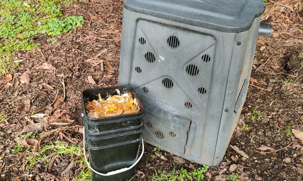 bokashi vs composting. a full bokashi bin next to a traditional compost bin