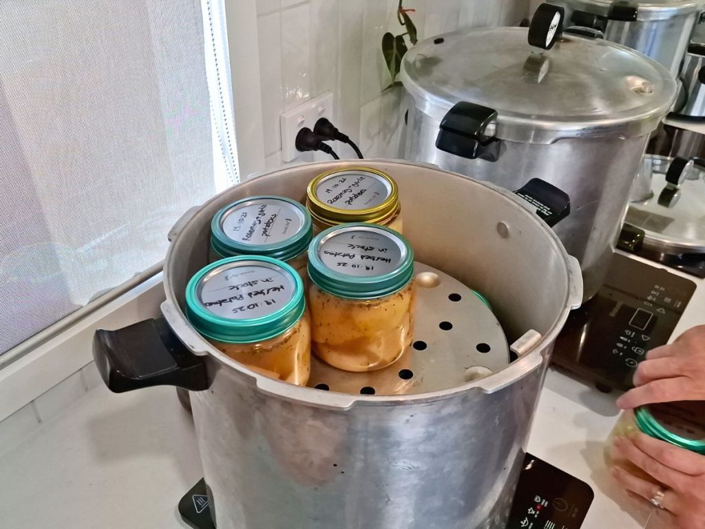 two pressure canners full of jars for pressure canning vegetables